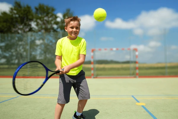 Boy playing tennis court happy 600nw 2407461719